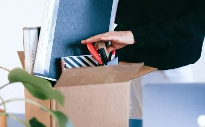person packing box at work